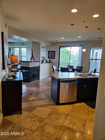 a living room with kitchen furniture and a open kitchen view