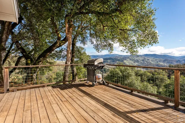 a view of balcony with wooden floor and fence