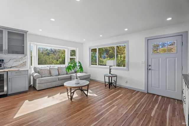 a living room with furniture and a wooden floor