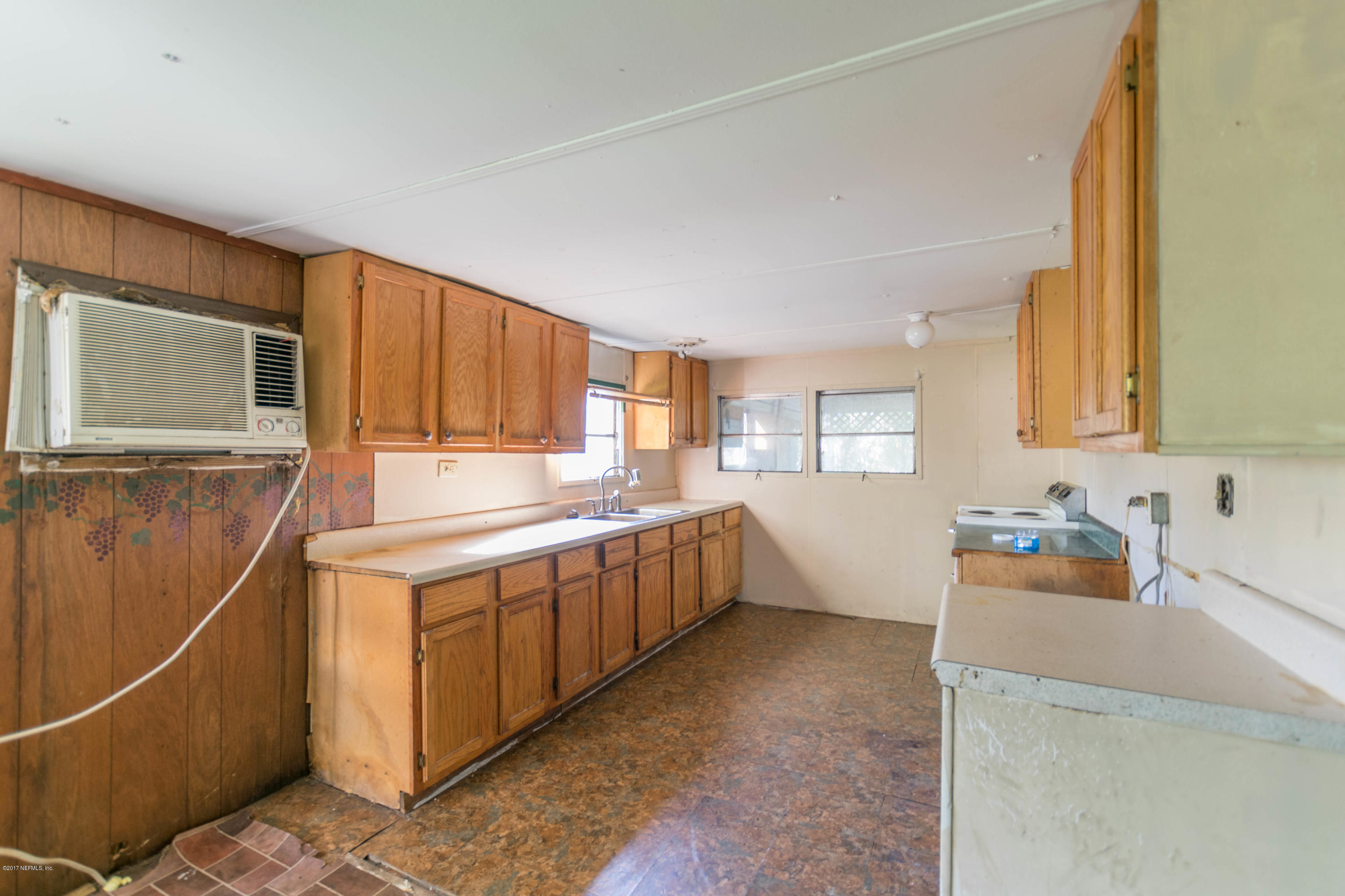 3713 Starratt Road Jacksonville, FL 32226 - Photo 2 of 11 a kitchen that has a sink and a stove in it