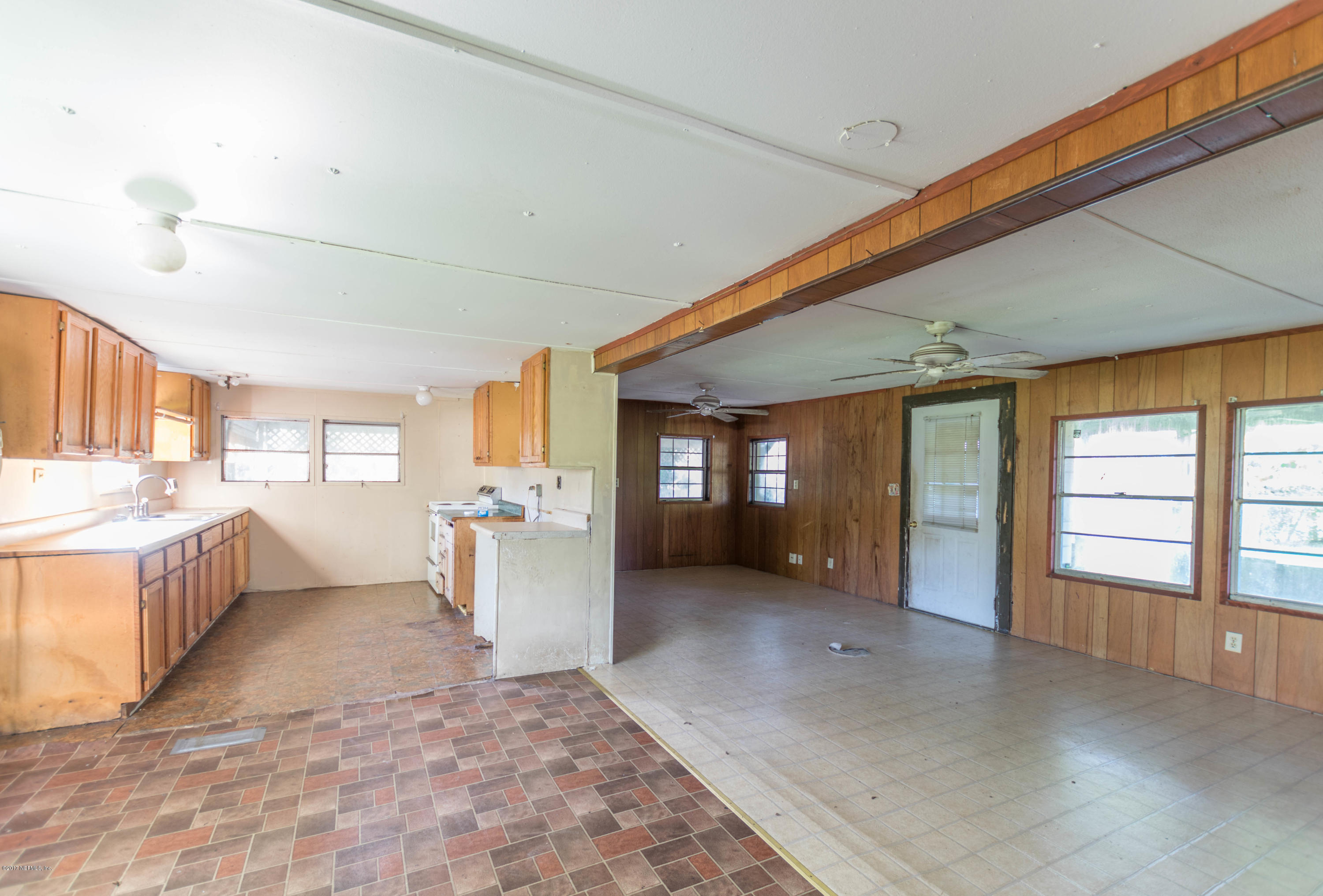 3713 Starratt Road Jacksonville, FL 32226 - Photo 3 of 11 a view of a kitchen with a sink and dishwasher a oven with large windows