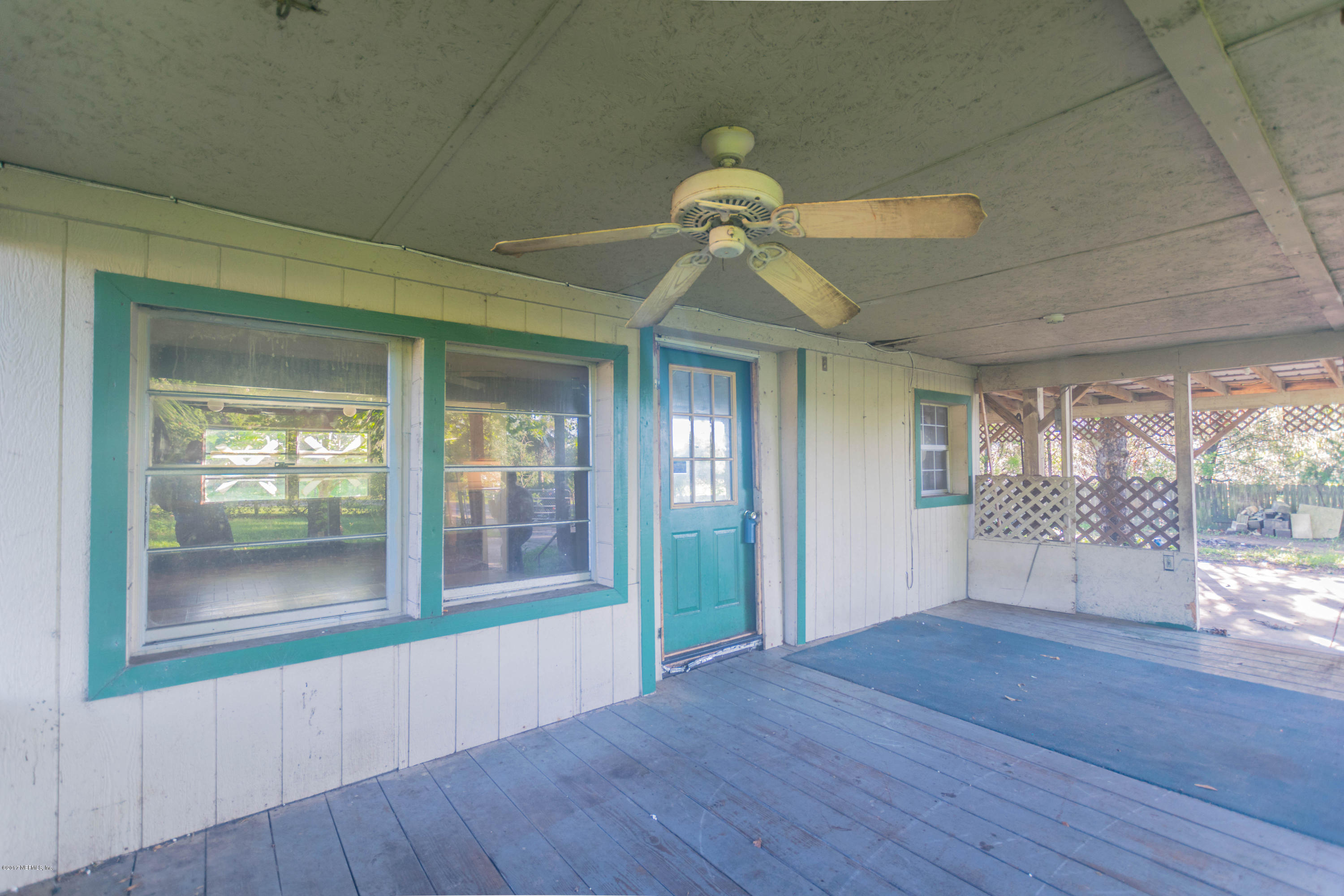 3713 Starratt Road Jacksonville, FL 32226 - Photo 9 of 11 a view of an empty room with wooden floor and a window
