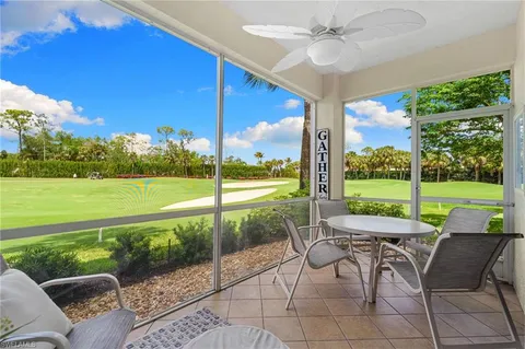 a view of a patio with a table chairs and a yard