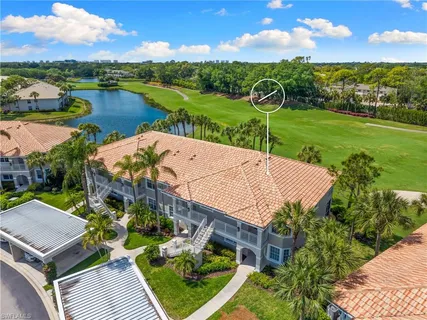 an aerial view of a house with outdoor space and lake view