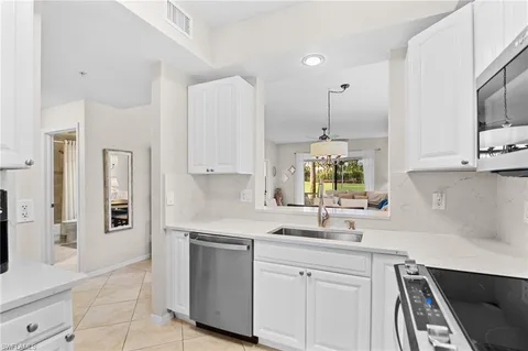 a kitchen with white cabinets and a sink
