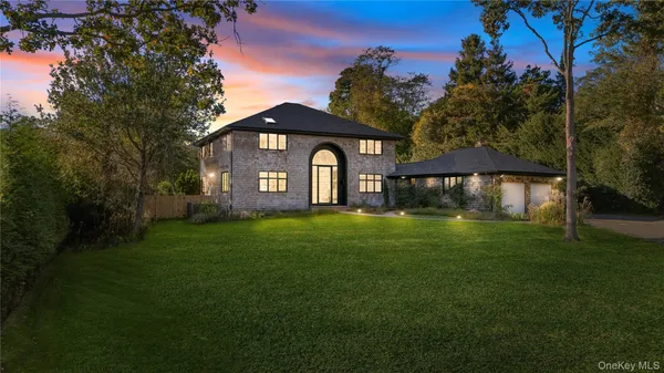 a front view of a house with a garden