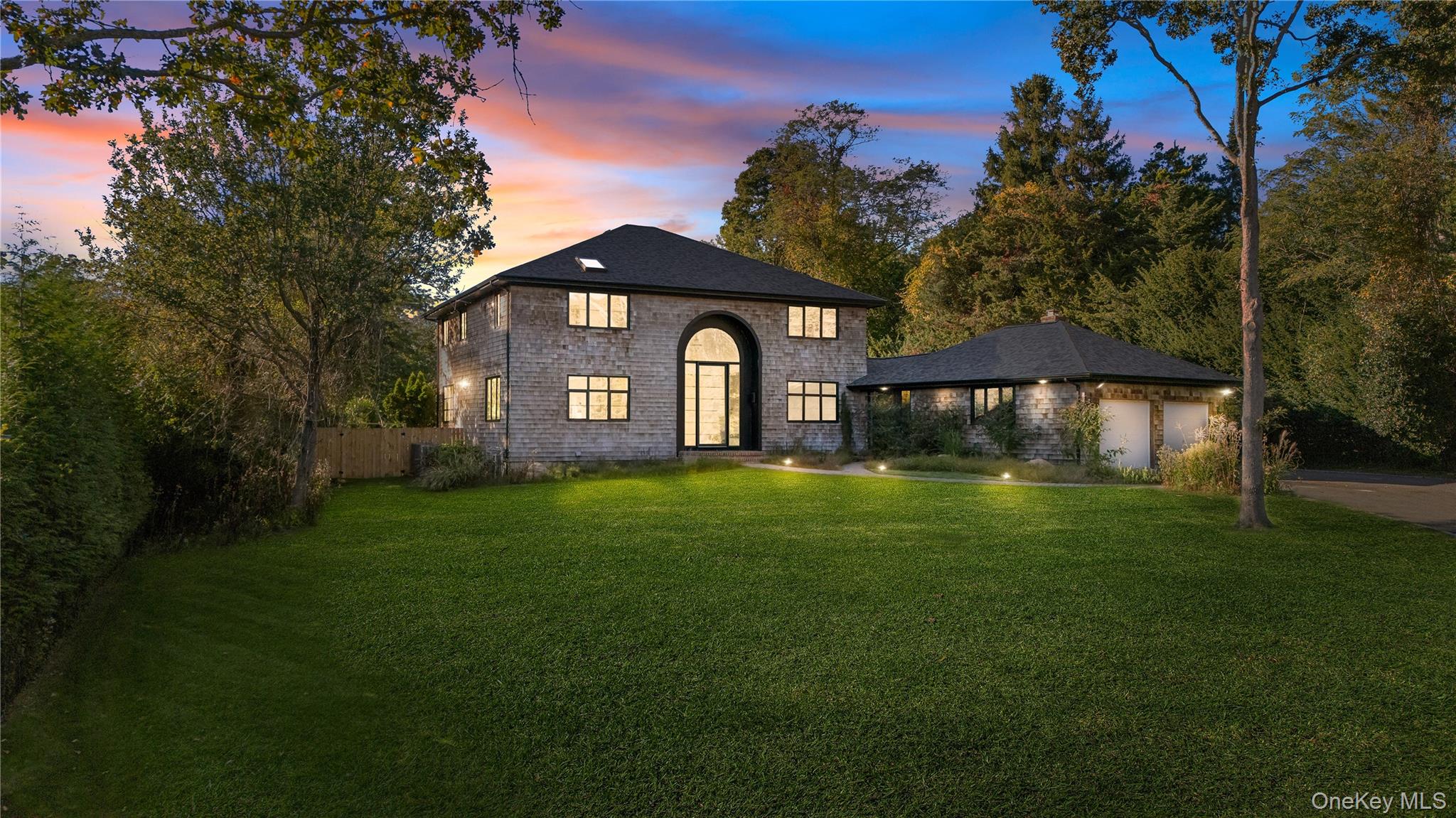 a front view of a house with a garden