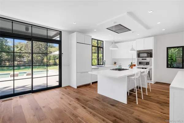 a view of a kitchen with furniture wooden floor and a window