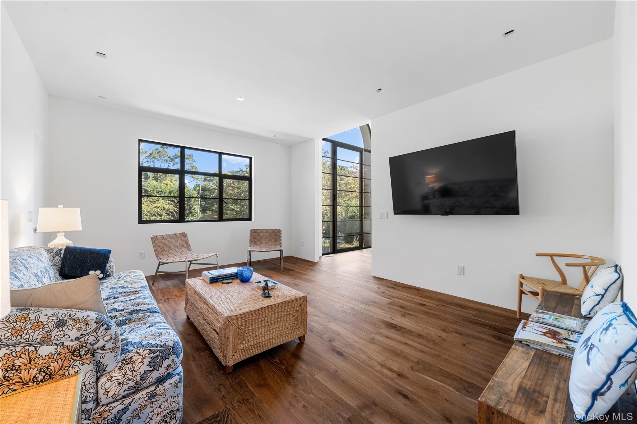 15 Atterbury Road Southampton, NY 11968 - Photo 20 of 46 a living room with furniture and a flat screen tv