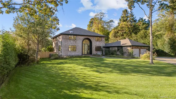 a front view of a house with a garden