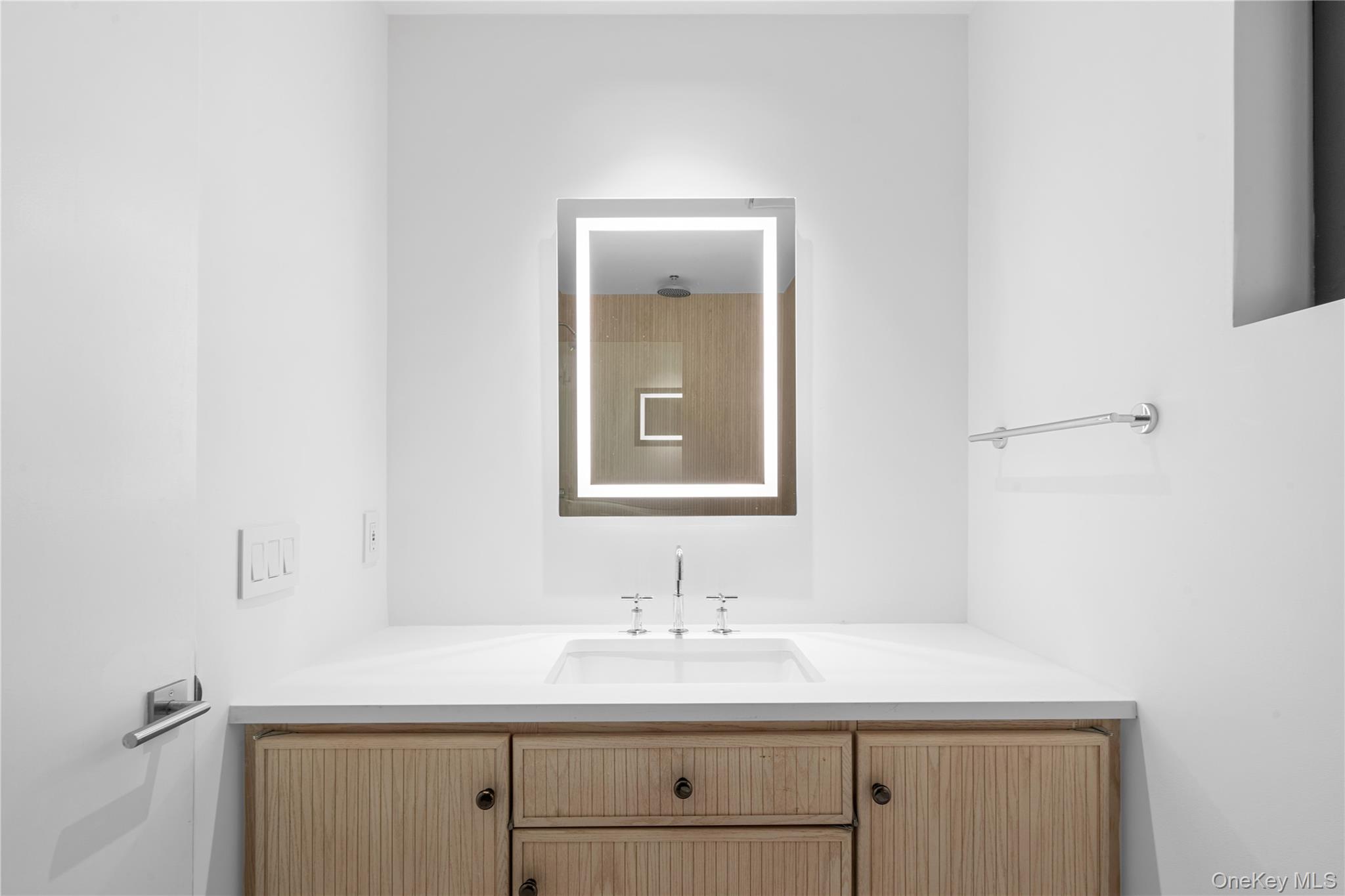 15 Atterbury Road Southampton, NY 11968 - Photo 21 of 46 a bathroom with a sink and a mirror