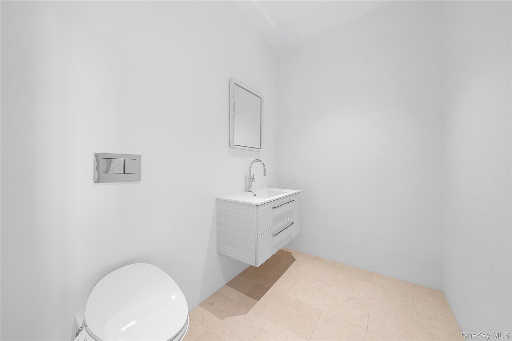 15 Atterbury Road Southampton, NY 11968 - Photo 22 of 46 a bathroom with a sink and mirror