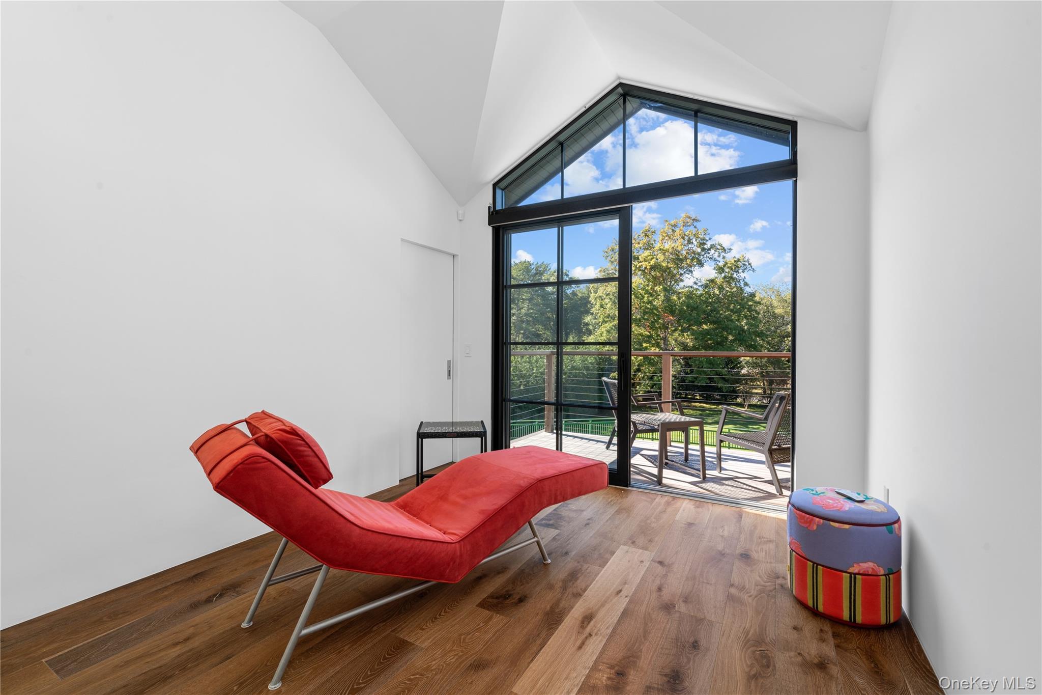 15 Atterbury Road Southampton, NY 11968 - Photo 23 of 46 a living room with furniture a wooden floor and a floor to ceiling window