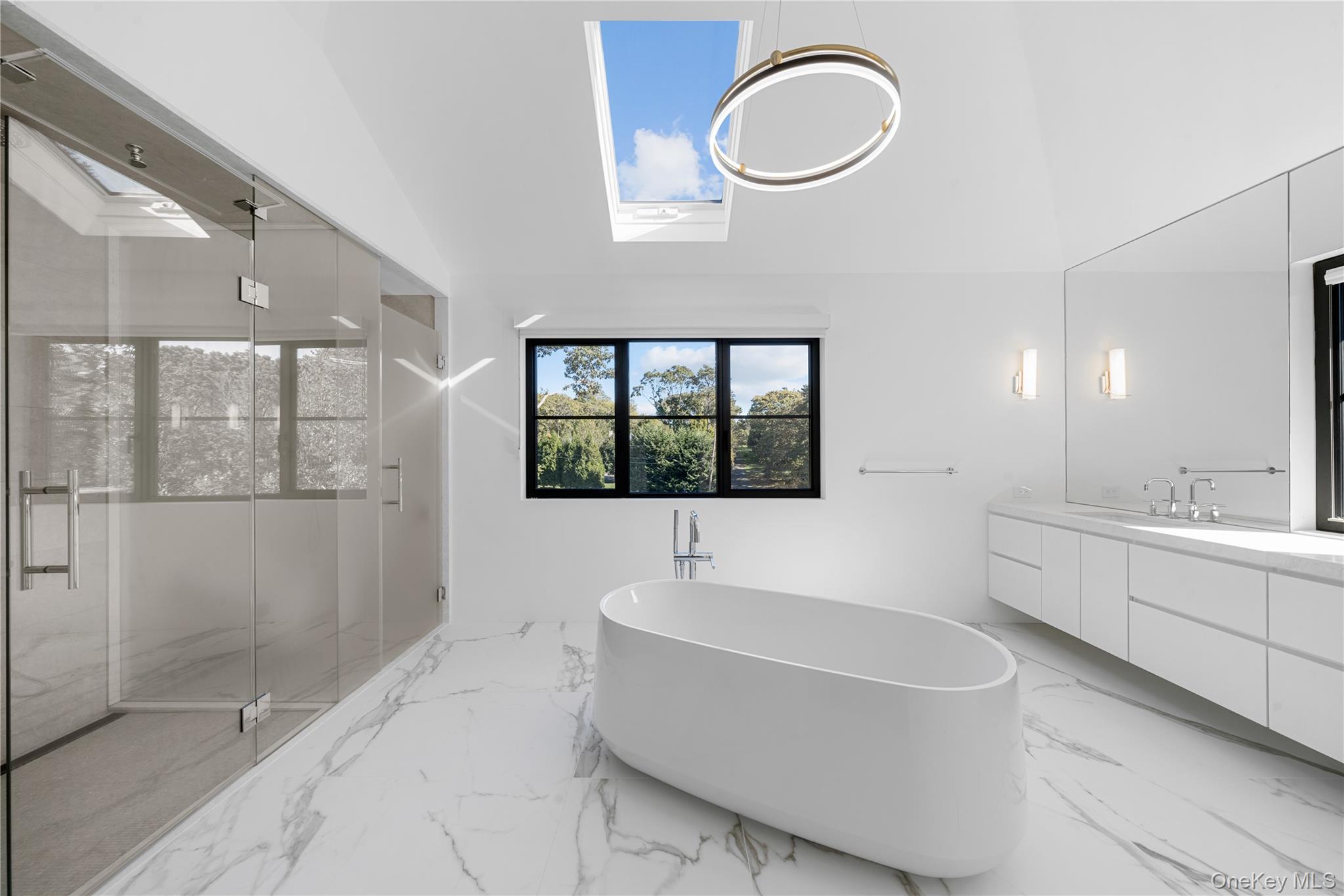 15 Atterbury Road Southampton, NY 11968 - Photo 28 of 46 a bathroom with a bathtub sink mirror vanity and toilet