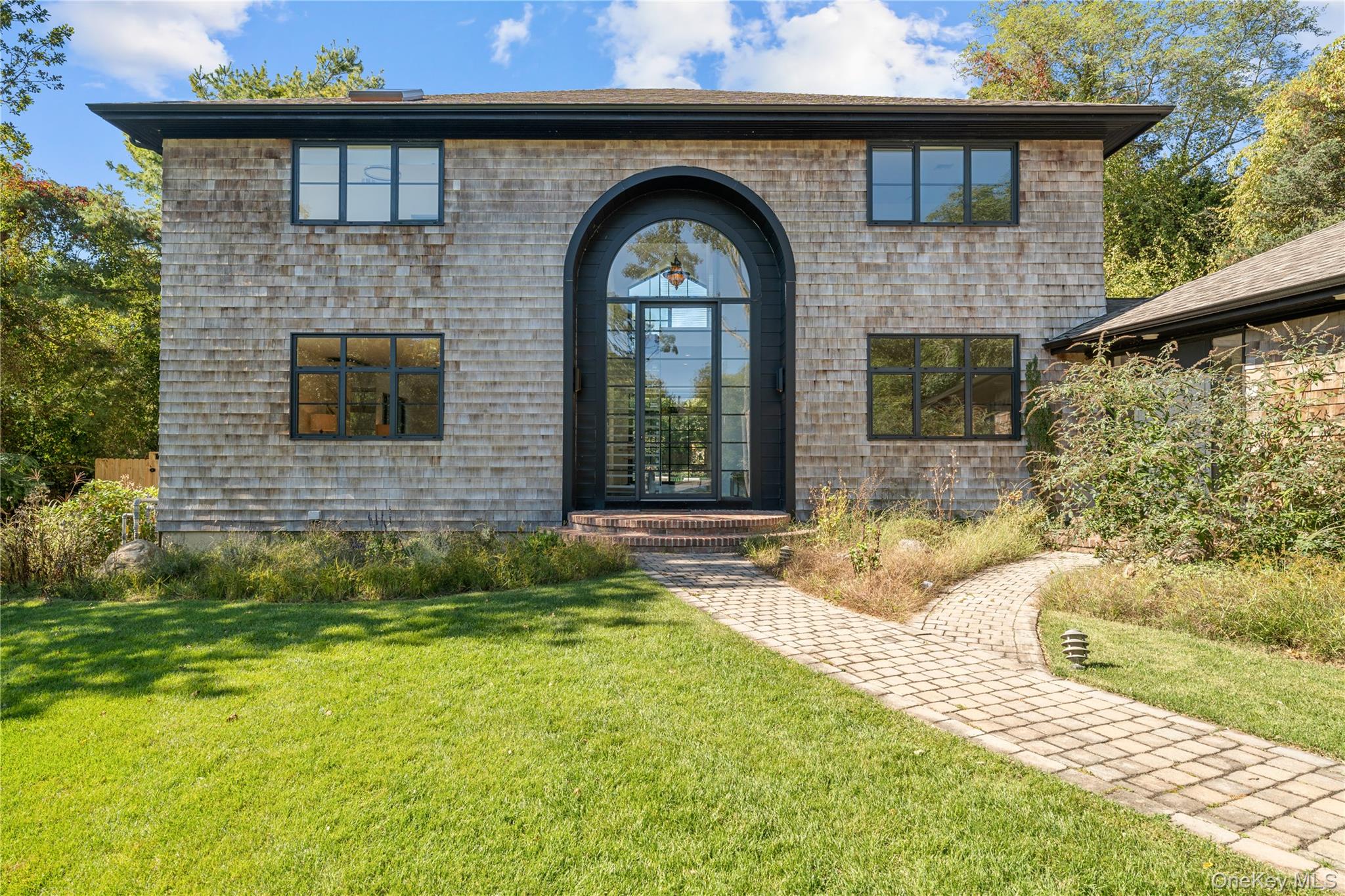 15 Atterbury Road Southampton, NY 11968 - Photo 3 of 46 a front view of a house with garden