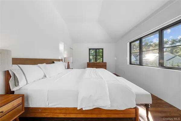 a bed sitting in a bedroom next to a window