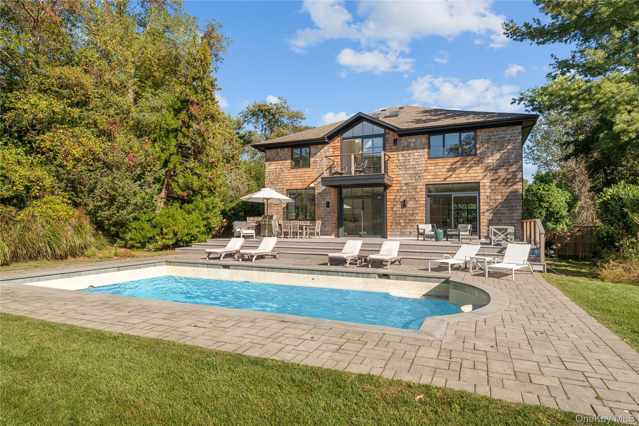 15 Atterbury Road Southampton, NY 11968 - Photo 43 of 46 a front view of a house with swimming pool having outdoor seating