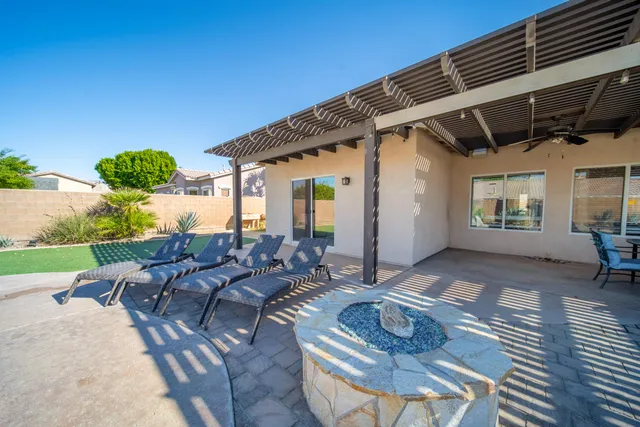 a view of a patio with table and chairs with wooden floor and fence