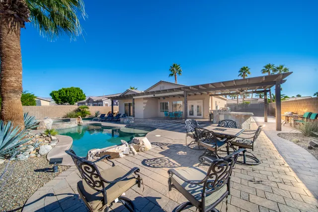 a view of a dinning table and chairs in patio