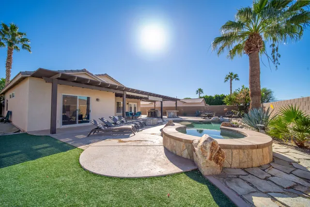 a view of a backyard with plants and patio