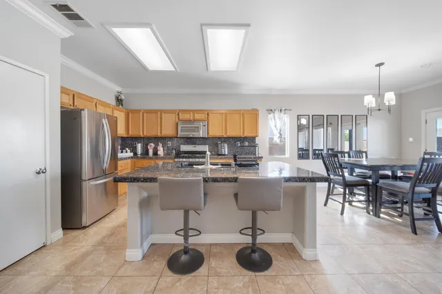 a large kitchen with a table and chairs