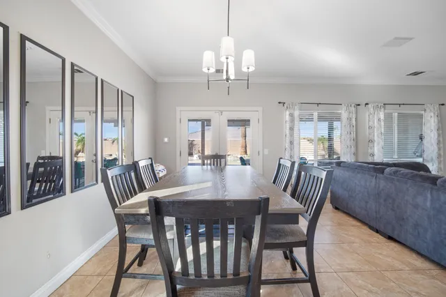 a view of a a dining room with furniture window and wooden floor