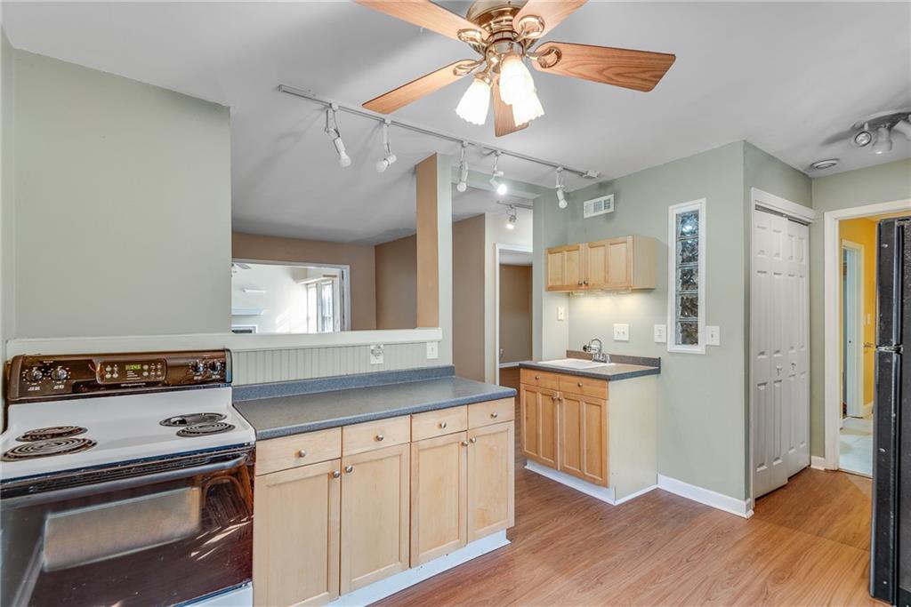 134 Lablanc Way Northwest Atlanta, GA 30327 - Photo 18 of 42 a kitchen with a stove a sink and a refrigerator
