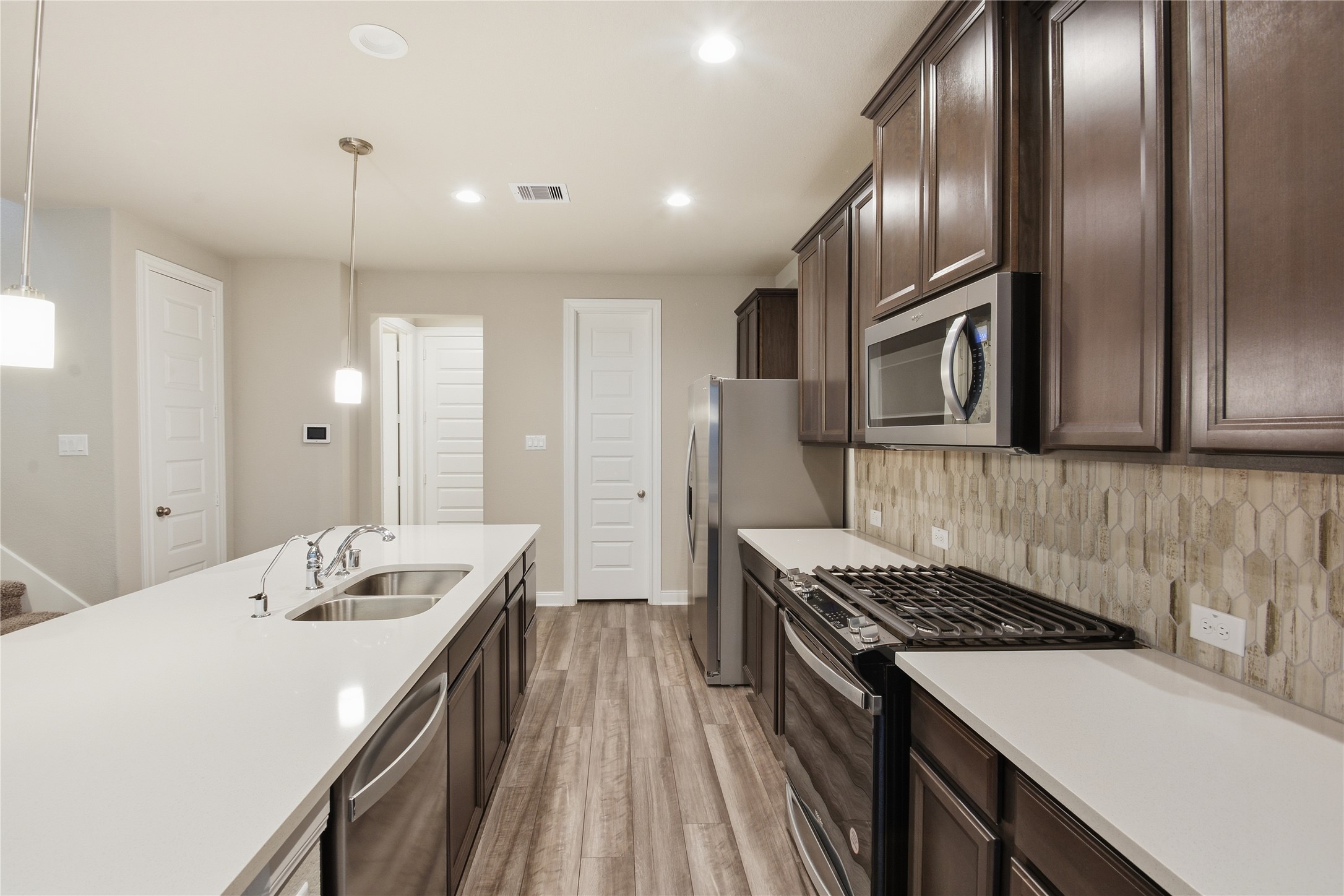 4106 Split Ivy Drive Houston, TX 77080 - Photo 11 of 34 a kitchen that has a sink stainless steel appliances and cabinets