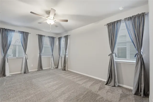 an empty room with windows and stairs