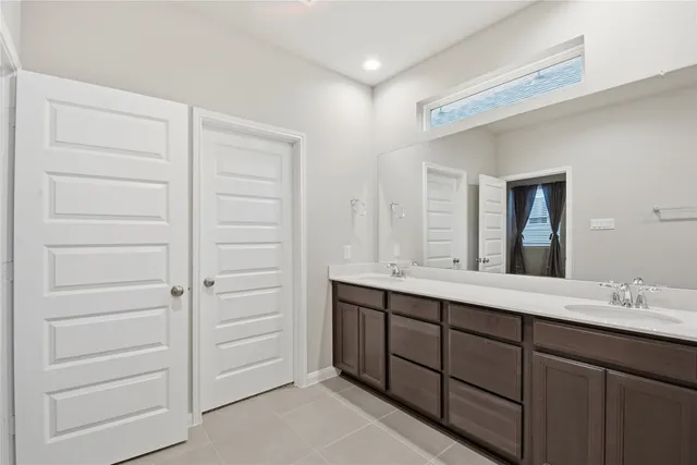 a bathroom with a double vanity sink and mirror