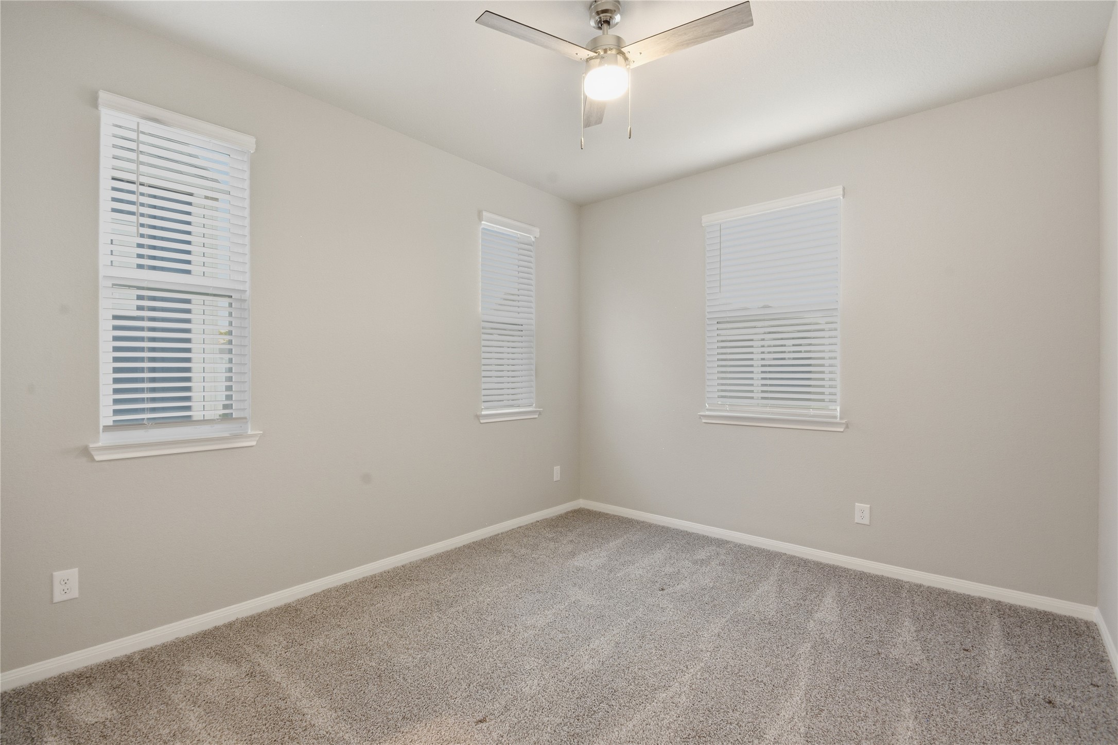 4106 Split Ivy Drive Houston, TX 77080 - Photo 24 of 34 an empty room with a window and a fan