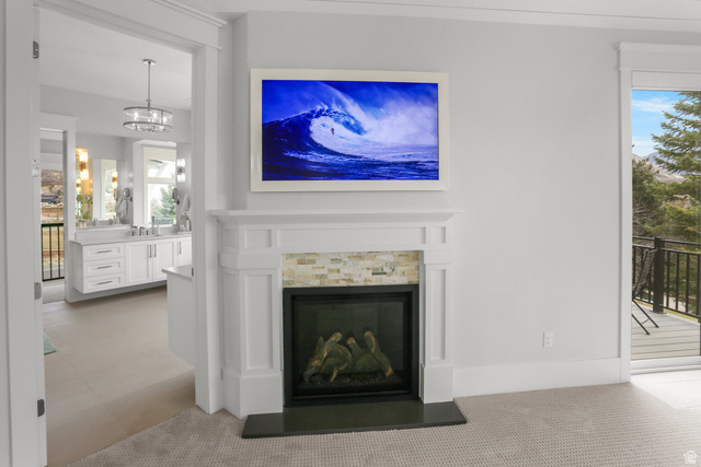 1354 South 800 East Mapleton, UT 84664 - Photo 34 of 129 Detailed view of a glass covered fireplace, suspended lighting, and carpet flooring