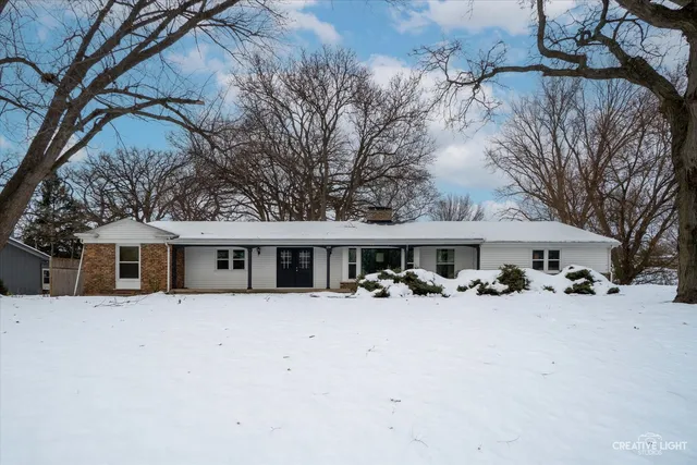 front view of a house with yard covered in snow