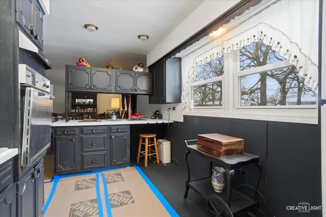 a kitchen with stainless steel appliances granite countertop a sink dishwasher and cabinets with wooden floor