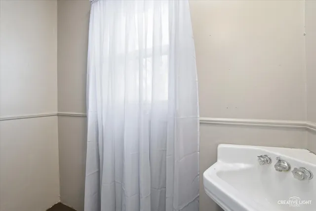 a bathroom with a sink and a window