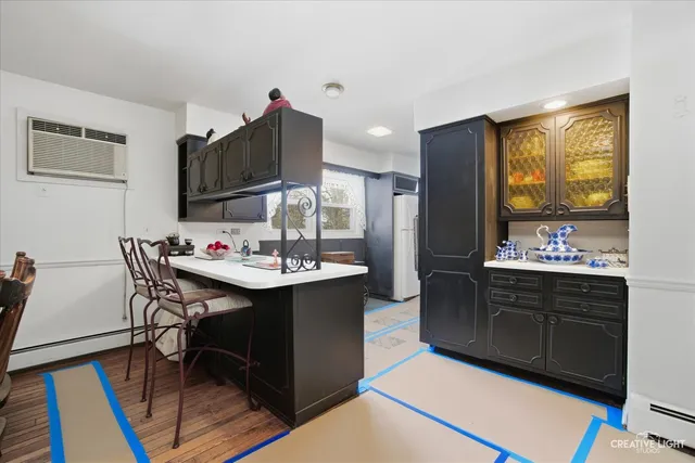 a kitchen with a sink cabinets and wooden floor