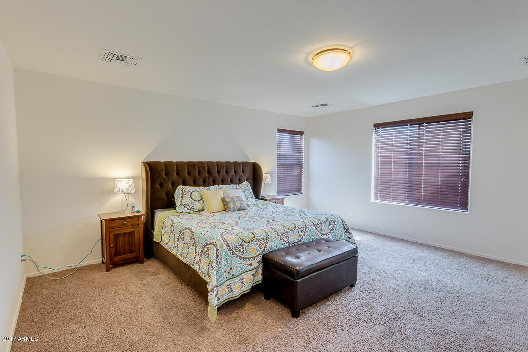 2099 South Martingale Road Gilbert, AZ 85295 - Photo 22 of 43 a spacious bedroom with a bed and a window