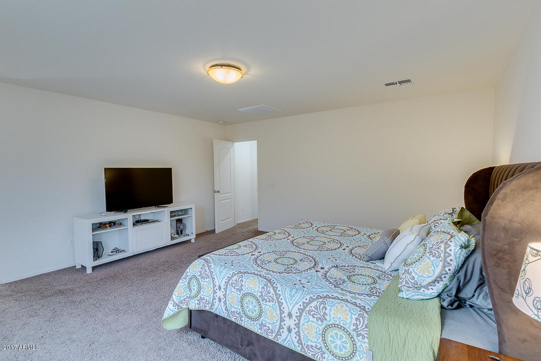 2099 South Martingale Road Gilbert, AZ 85295 - Photo 24 of 43 a bedroom with a bed and a flat screen tv