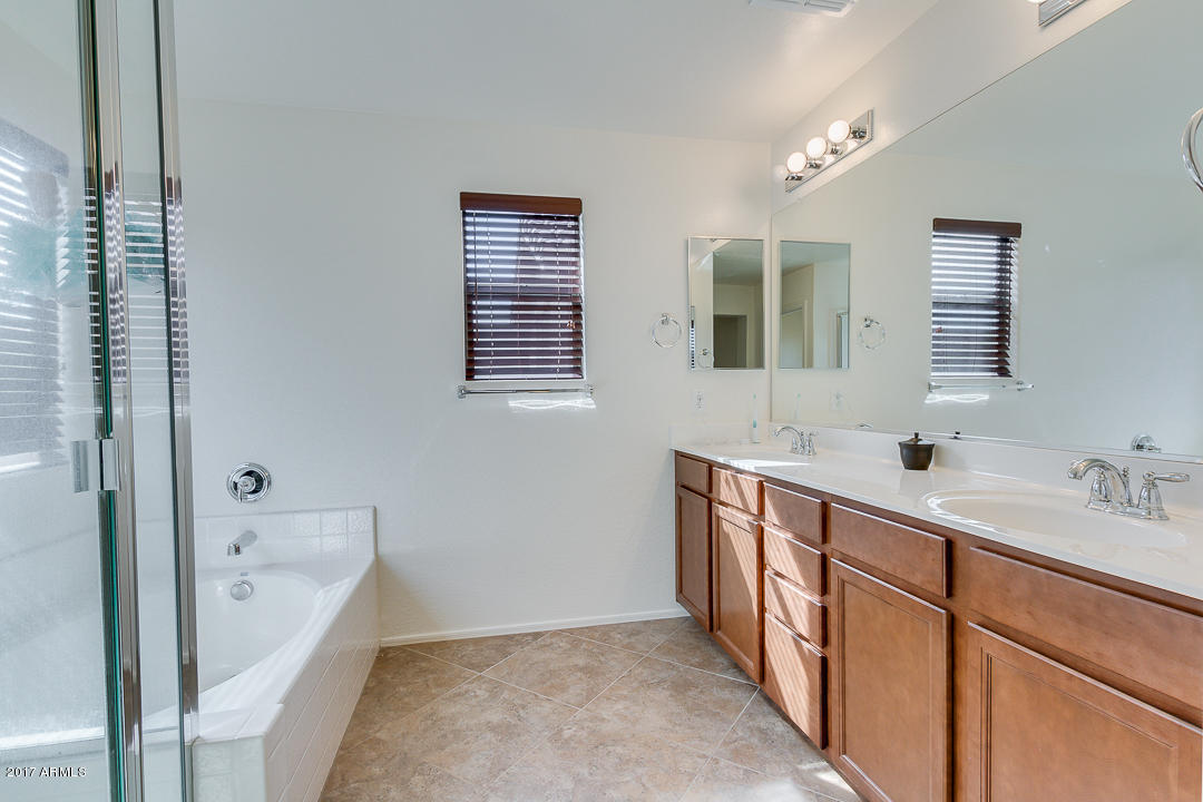 2099 South Martingale Road Gilbert, AZ 85295 - Photo 26 of 43 a spacious bathroom with double vanity and a bathtub