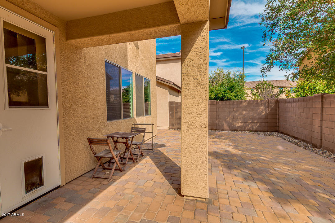 2099 South Martingale Road Gilbert, AZ 85295 - Photo 36 of 43 a patio with table and chairs and potted plants