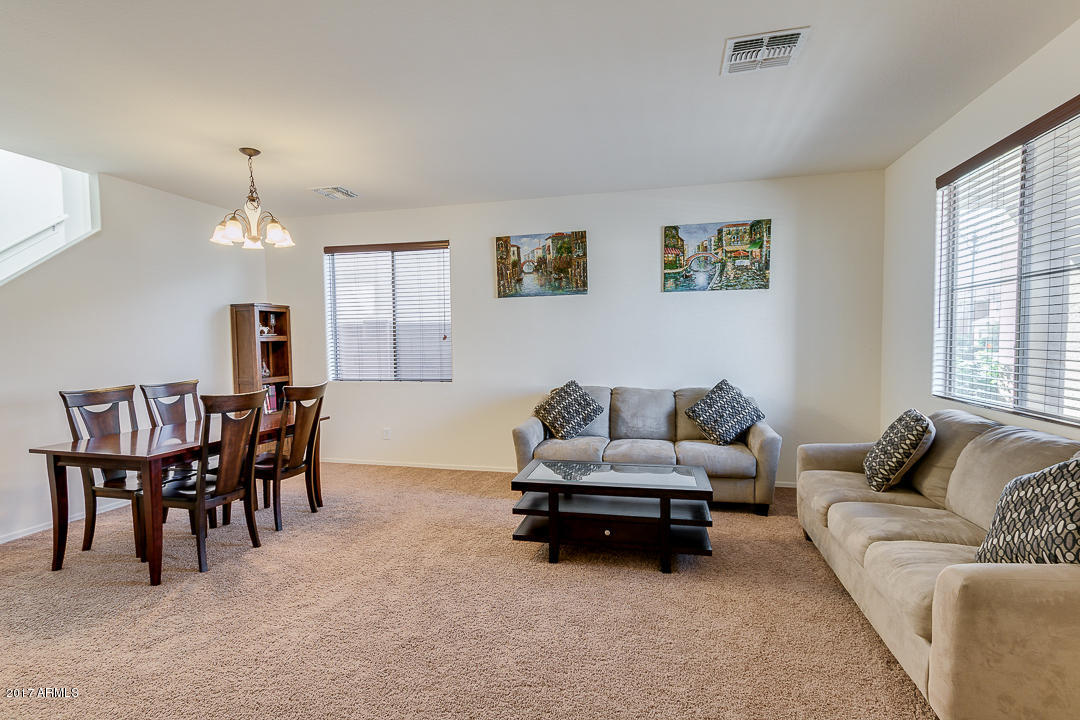 2099 South Martingale Road Gilbert, AZ 85295 - Photo 4 of 43 a living room with furniture and a chandelier
