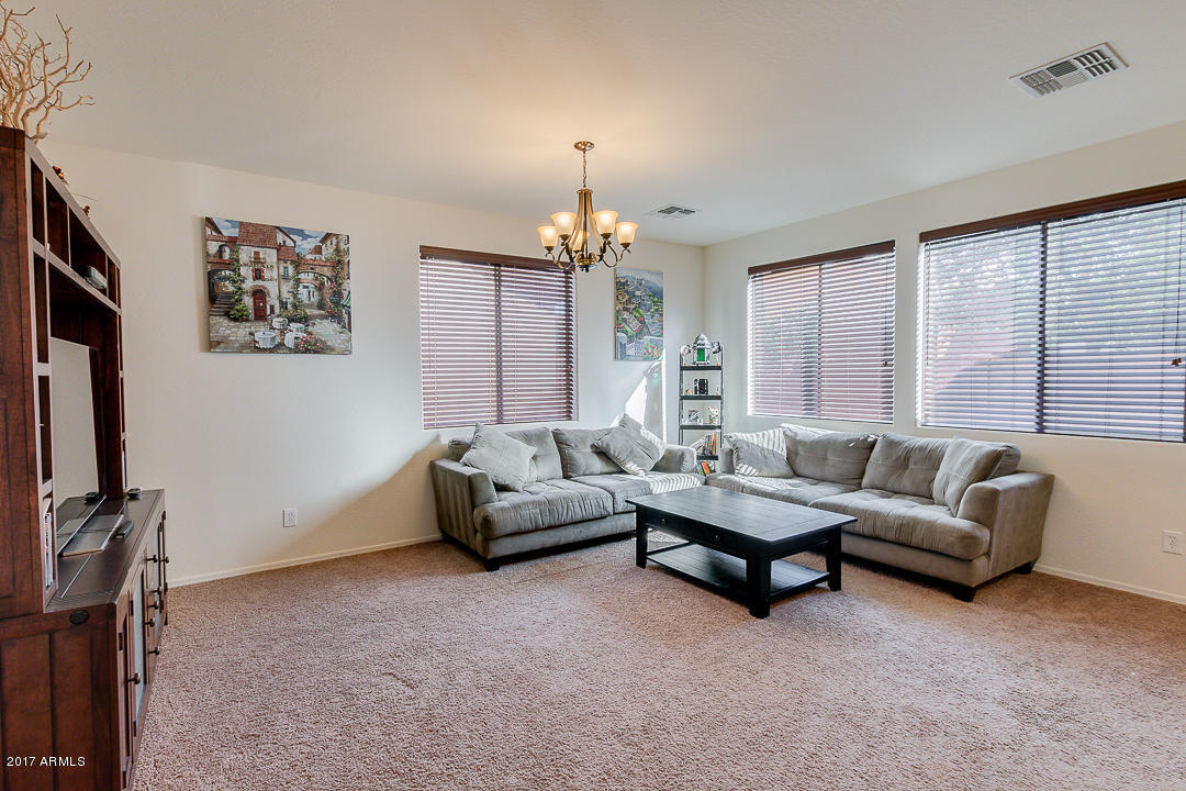 2099 South Martingale Road Gilbert, AZ 85295 - Photo 9 of 43 a living room with furniture and a flat screen tv