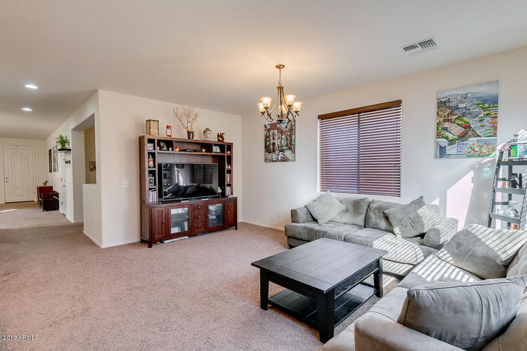 2099 South Martingale Road Gilbert, AZ 85295 - Photo 10 of 43 a living room with furniture and a chandelier