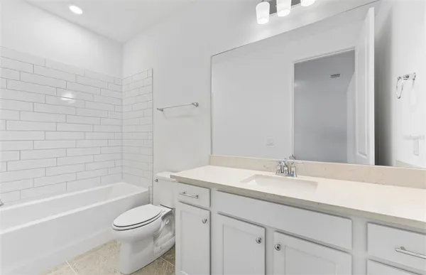 a bathroom with a sink a toilet and bathtub