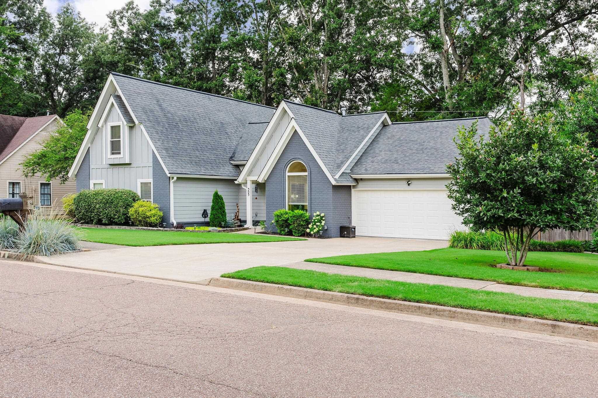305 Great Falls Road Collierville, TN 38017 - Photo 1 of 23 Single-family residence featuring a two-car garage, pitched shingle roof, and a paved driveway