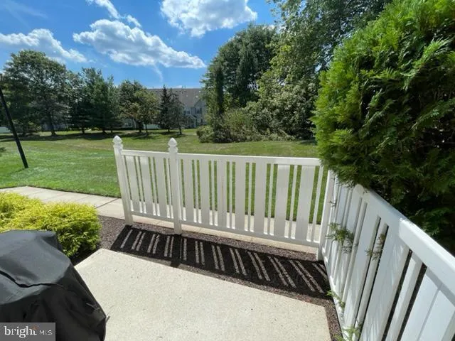 a view of a roof deck with couches and a big yard