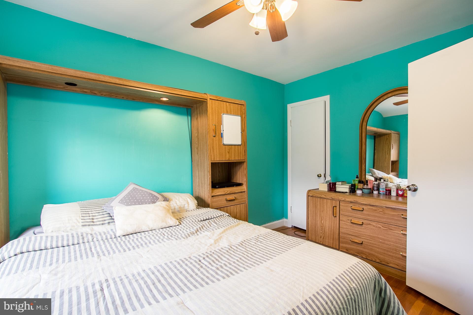 4444 Fenor Road Baltimore, MD 21227 - Photo 12 of 26 a bedroom with a bed and a chandelier