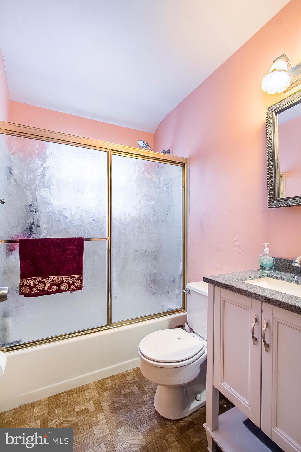 4444 Fenor Road Baltimore, MD 21227 - Photo 14 of 26 a bathroom with a toilet a sink and a shower