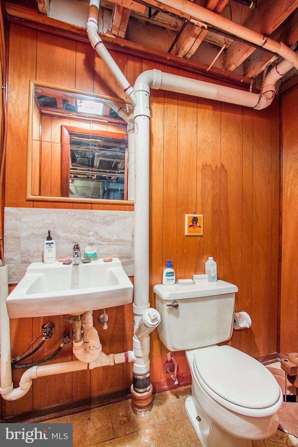 4444 Fenor Road Baltimore, MD 21227 - Photo 20 of 26 a white toilet sitting next to a bathroom sink