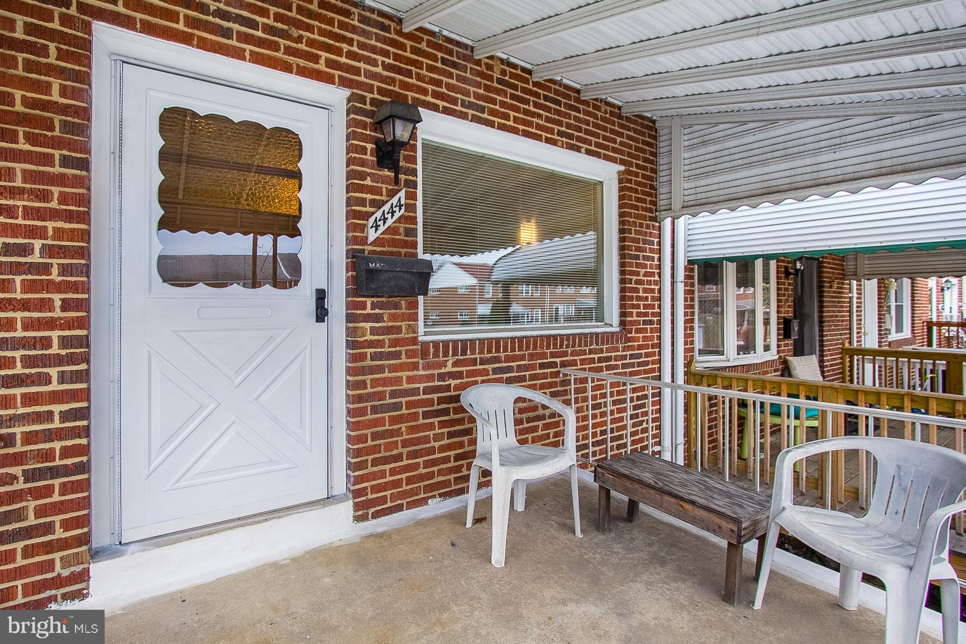 4444 Fenor Road Baltimore, MD 21227 - Photo 25 of 26 a view of front door of house with outdoor seating